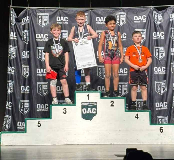 Colton Turle of Twinsburg Wrestling Club standing on the first-place podium as the Div 2 OAC Berea Midpark District Champion